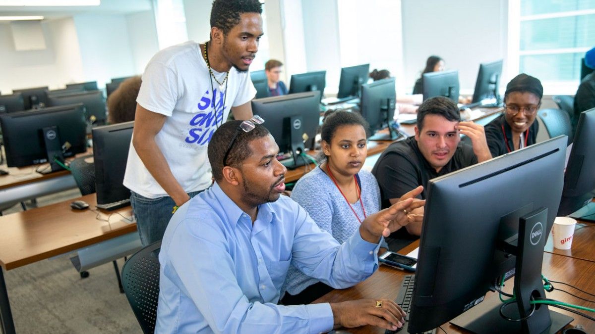 Hakim Weatherspoon, professor of computer science, works with students during the 2019 SoNIC Workshop program in Upson Hall. CREDIT: Jason Koski, Cornell University Hakim Weatherspoon, professor of computer science, works with students during the 2019 SoNIC Workshop program in Upson Hall. CREDIT: Jason Koski, Cornell University