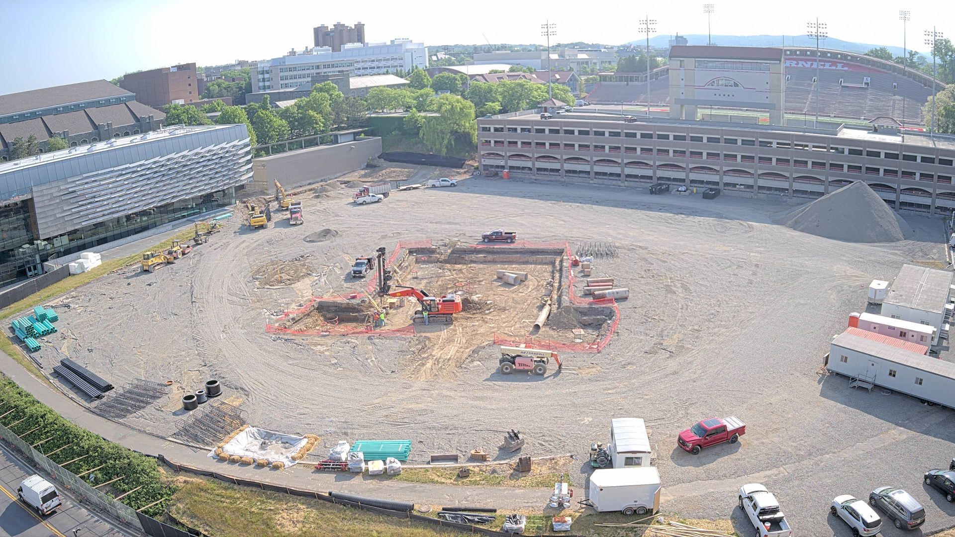 Aerial view of construction site for the new Bowers CIS building. Shows several large machinery and trucks and a hole where the south wing of the building will be.