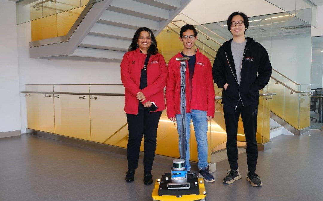 AutoPhoto, a robotic system developed by a trio of researchers from the Cornell Ann S. Bowers College of Computing and Information Science that can automatically roam an interior space and capture aesthetically pleasing photographs. Researchers standing with robot