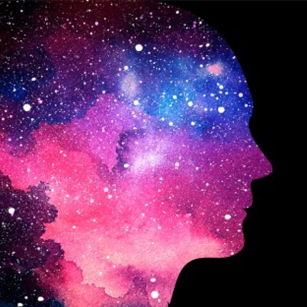 A color photo showing a silhouette of a face with outer space clouds in the bg. Shutterstock