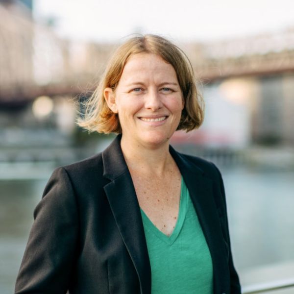 A color photo of a woman smiling for a photo