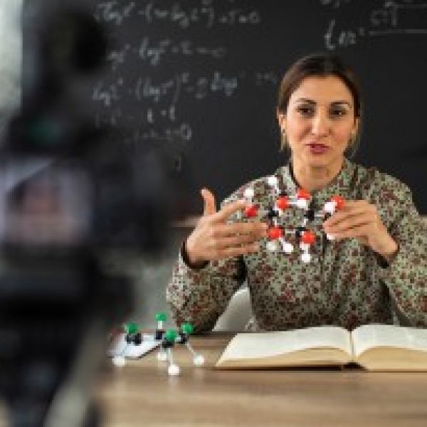 A woman leading an online class.