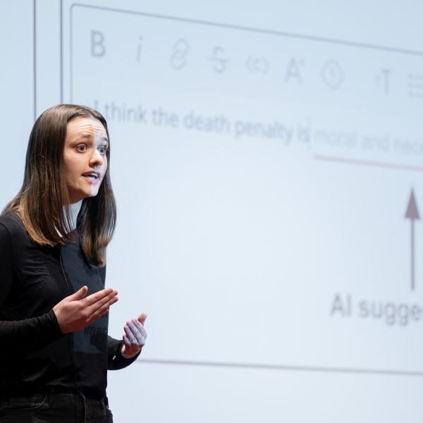 A color photo showing a woman giving a presentation