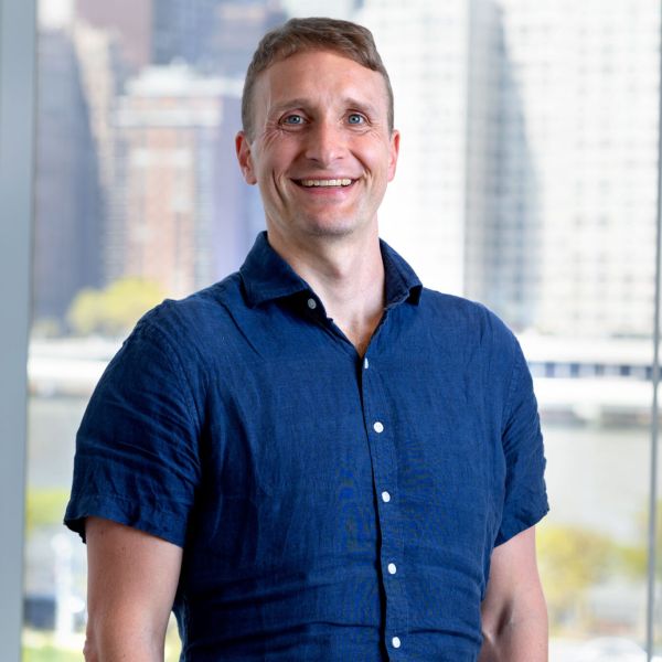 A color photo of a man smiling for a photo