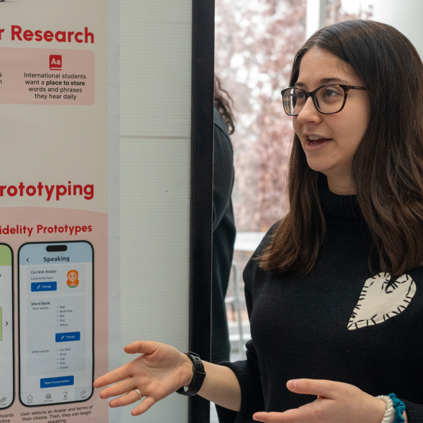 Dina Shlufman ‘27, an information science major, presents her team’s app prototype, “Slang Central,” during a joint poster session for two human-computer interaction courses in the Physical Sciences Building on Tuesday, Dec. 10. (Photo by Luke Stewart)