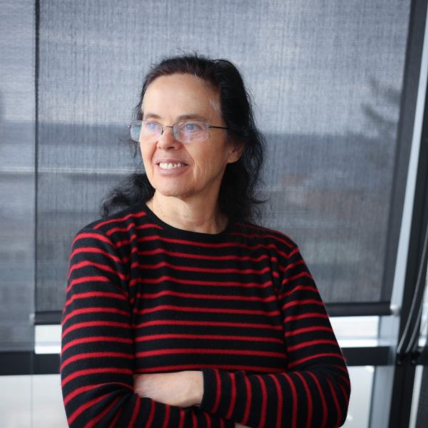 A color photo of a woman smiling for a photo