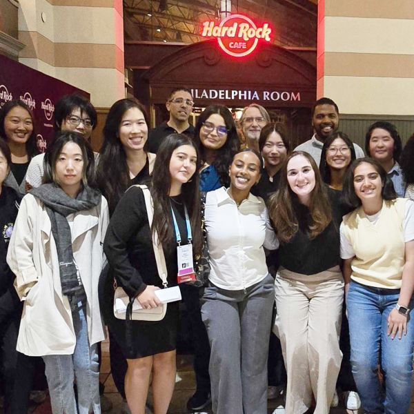 A color photo showing a group of people smiling for a photo