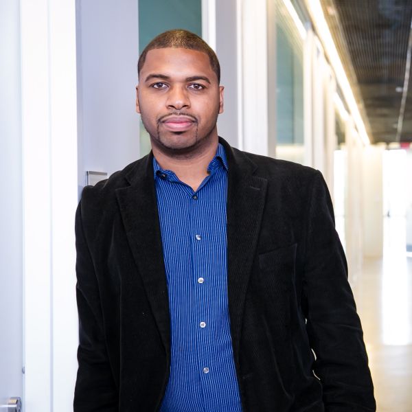 man in hallway looking at camera