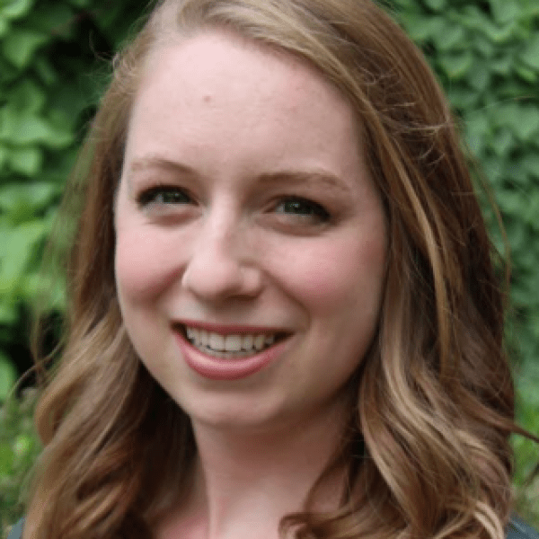 A color photo of a woman smiling for a photo