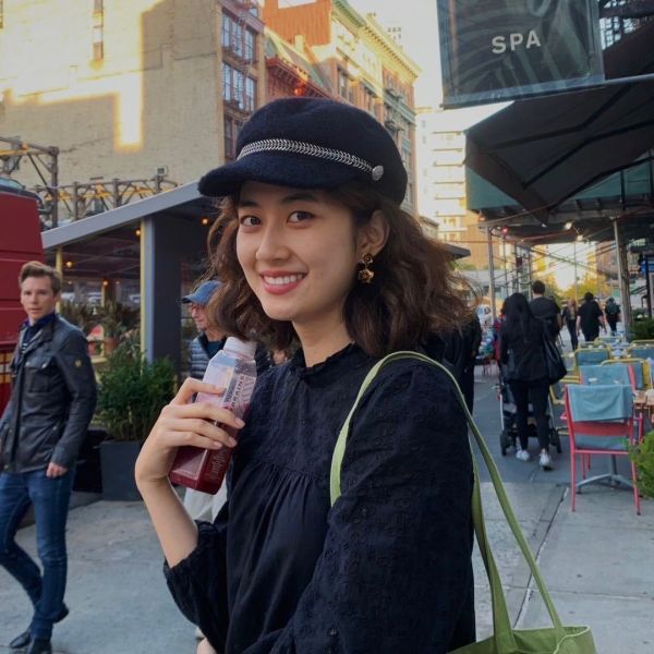 A color photo of a woman smiling for a photo