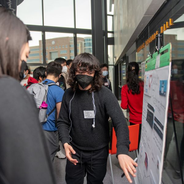 student presenting a poster