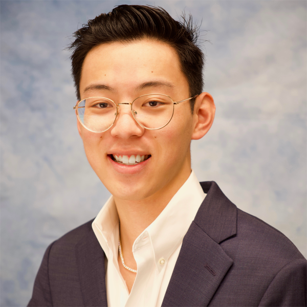 A color photo of a man smiling for a photo