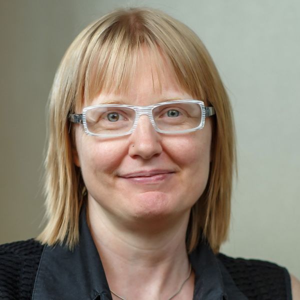 A color photo of a woman smiling for a photo