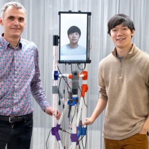 Cornell Bowers CIS Professor François Guimbretière and PhD student Mose Sakashita posing with the VRoxy robotic system.