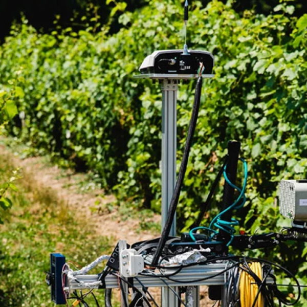 A color photo of a robotic device working in agriculture
