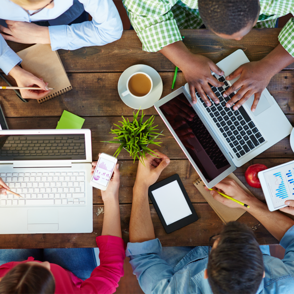 A color photo showing an overhead shot of people working together in a group