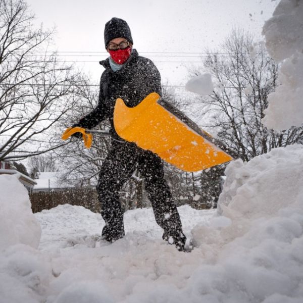 Matt Braun, a resident of the Fall Creek neighborhood in the city of Ithaca, shovels snow Feb. 2 at the corner of Tompkins and Utica streets.