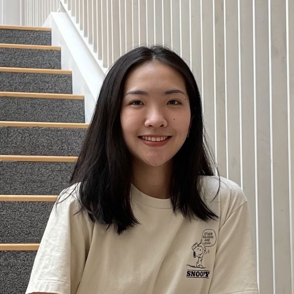 A color photo of a woman smiling for a photo