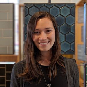 A color photo of a woman smiling for a photo