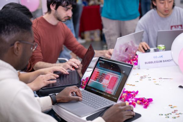 A color photo showing people playing video games