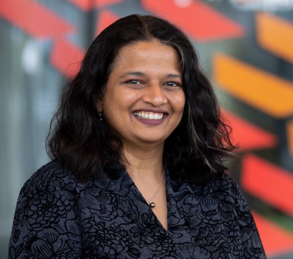 Dean Kavita Bala Woman smiling and looking at camera