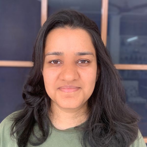Tanya Goyal A color photo of a woman smiling for a photo