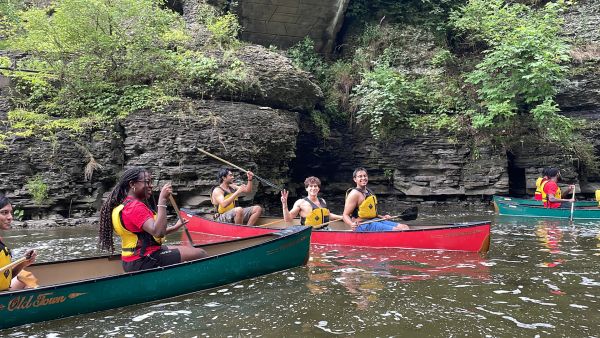 A color photo showing people canoeing