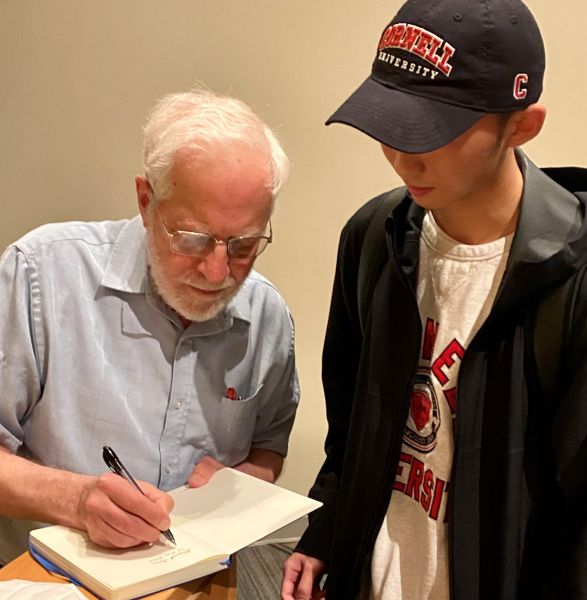 Gries signs a notebook of a student