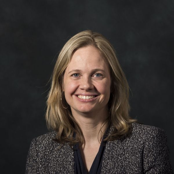 A color photo of a woman smiling for a photo