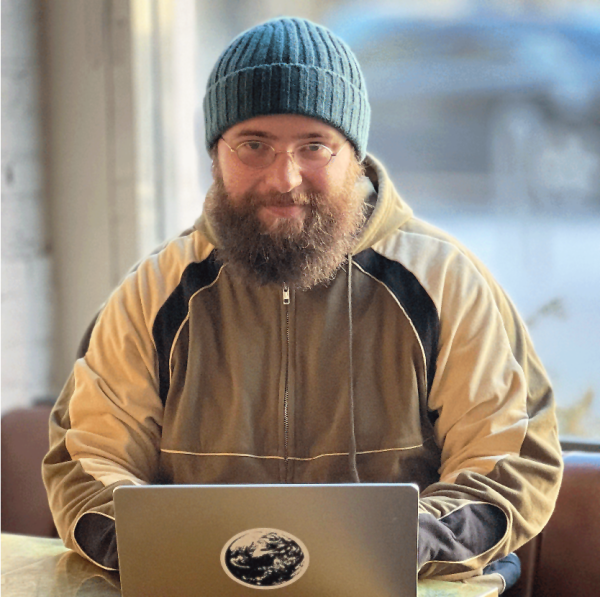 A color photo of a man smiling for a photo