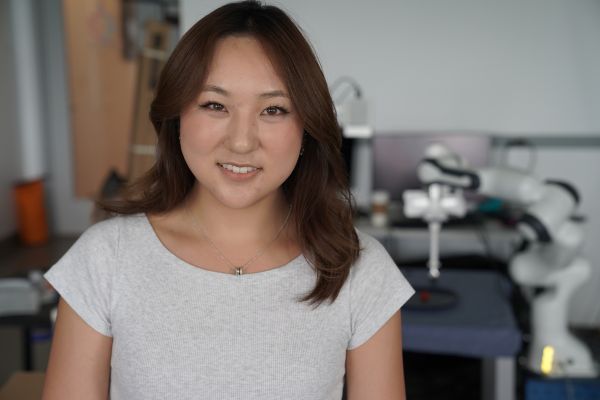 A color photo of a woman smiling for a photo