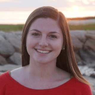 A color photo of a woman smiling for a photo