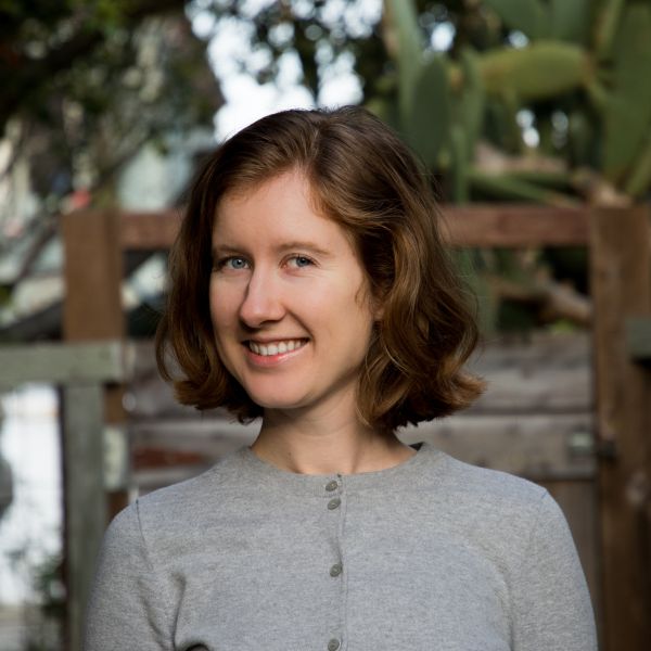 A color photo of a woman smiling for a photo