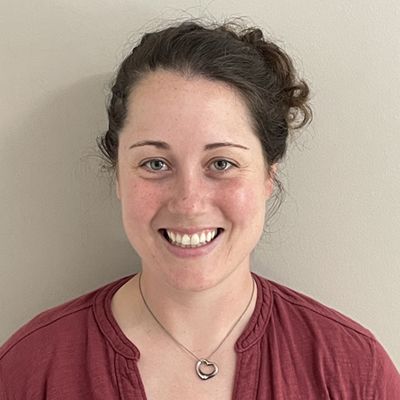 A color photo of a woman smiling for a photo