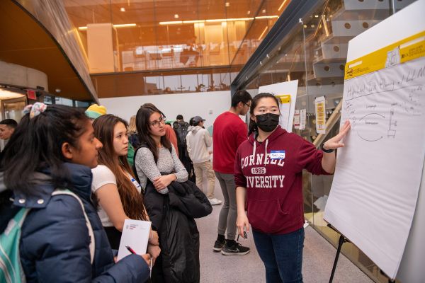 Researchers share work, opportunities at ACSU Research Night A color photo of someone presenting research to a crowd