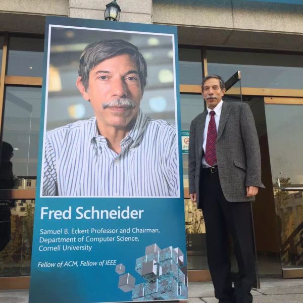 Fred Schneider next to a poster dedicated to him