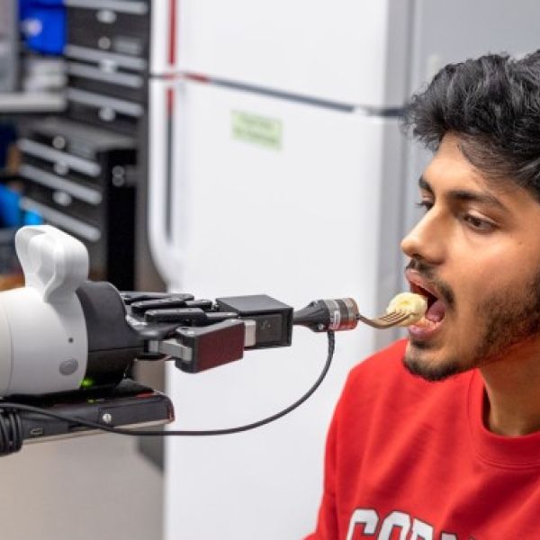 Man being fed by a robot