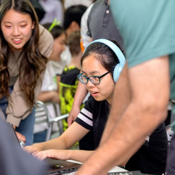 A color photo showing visitors at the 2023 GDIAC showcase play new student games.