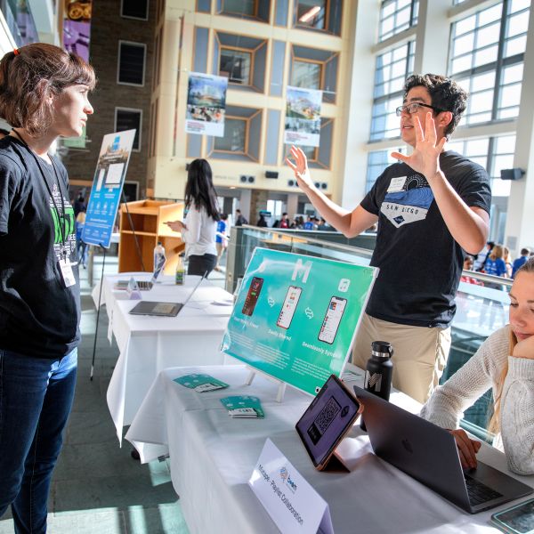 A color photo of someone presenting a project to another person