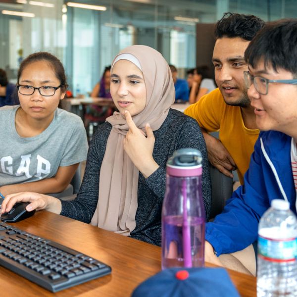 group writing code on a computer