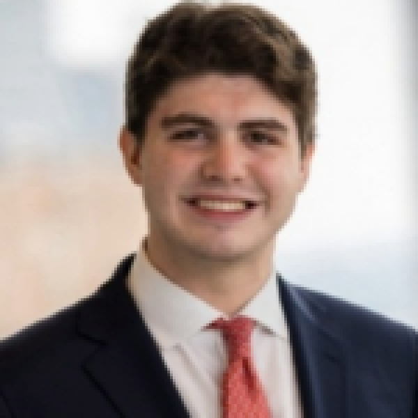 A color photo of a man smiling for a photo