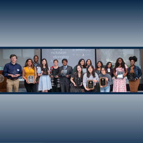 A color photo showing a group of award winners with their awards