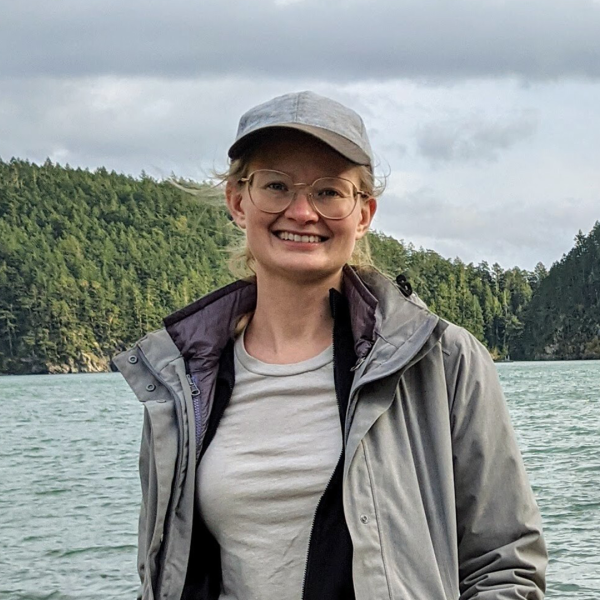 A color photo of a woman smiling for a photo