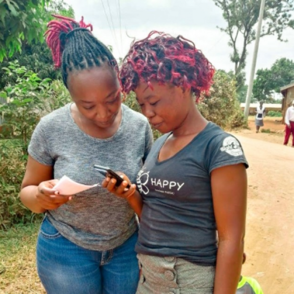 A user tests a new phone-based tool for providing health care feedback with a member of the research team.