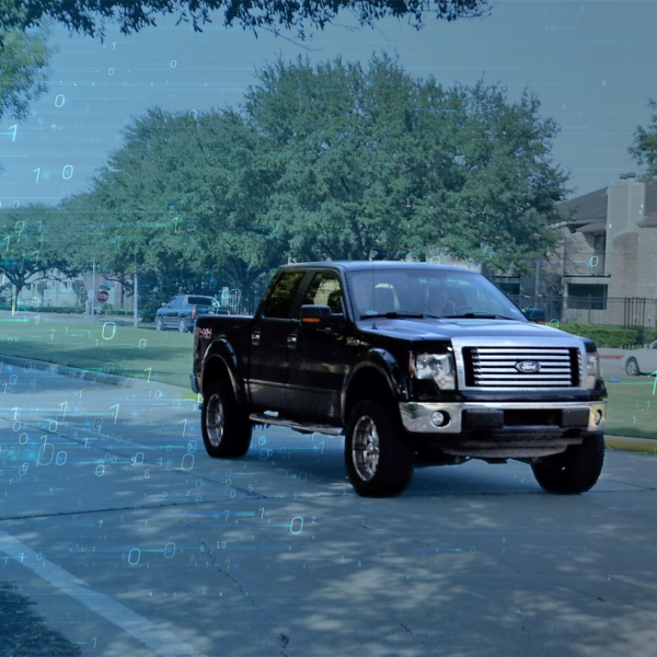 Color photo of a pick-up truck on a city street