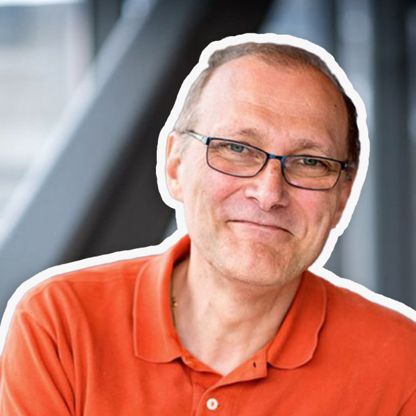 A color photo of a man smiling for a photo