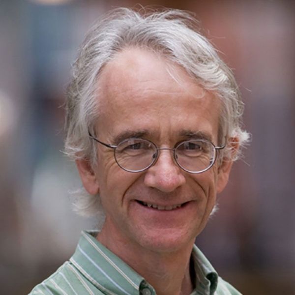A color photo of a man smiling for a photo